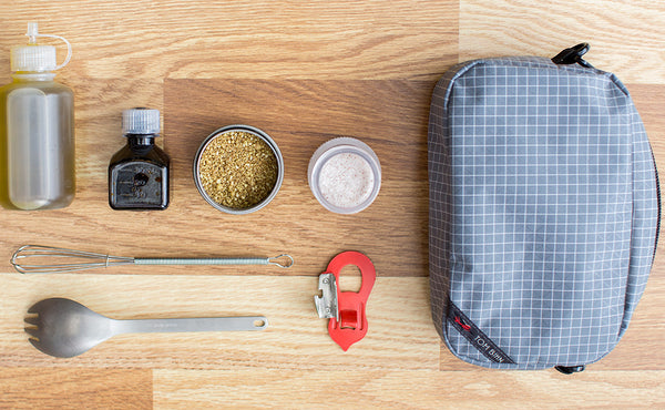 A small meal kit (sweetener, soy sauce, spices, a metal straw, a metal spork, and a palm-sized can and bottle opener) that will fit in a 3D Organizer Cube.